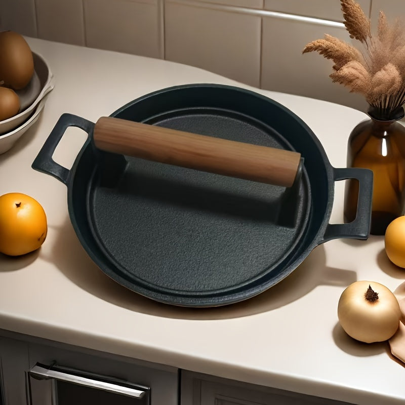 Set of a round cast iron frying pan, a striped meat press, and a meat board for steak frying and pressing.