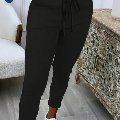 Women's plus size solid color straight leg pants with pockets, drawstring, and relaxed fit for casual wear.