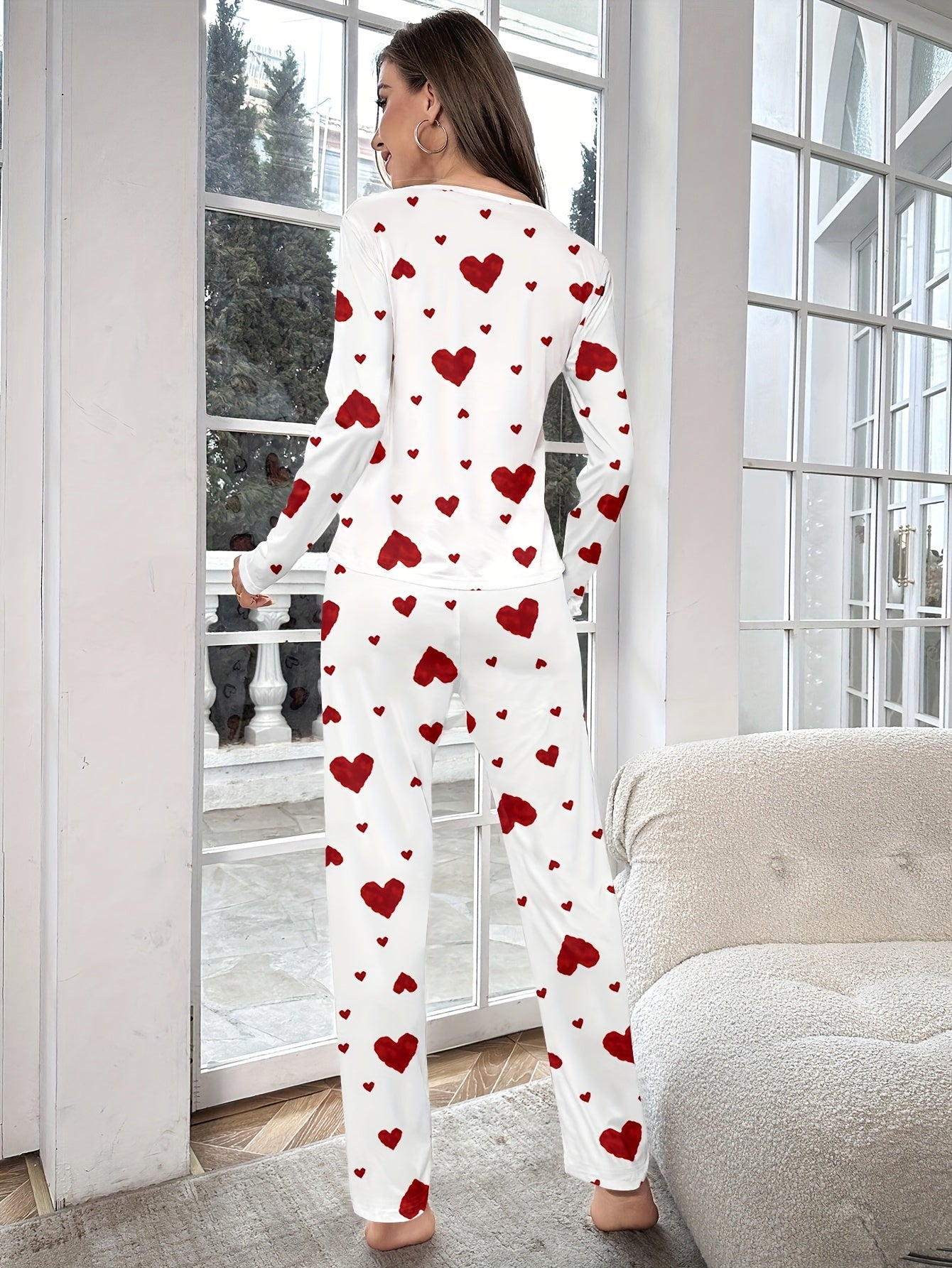 Women's heart print pajama set with round neck and long sleeves. Made from polyester, perfect for cozy home wear in autumn/winter. Includes long pants and pullover.