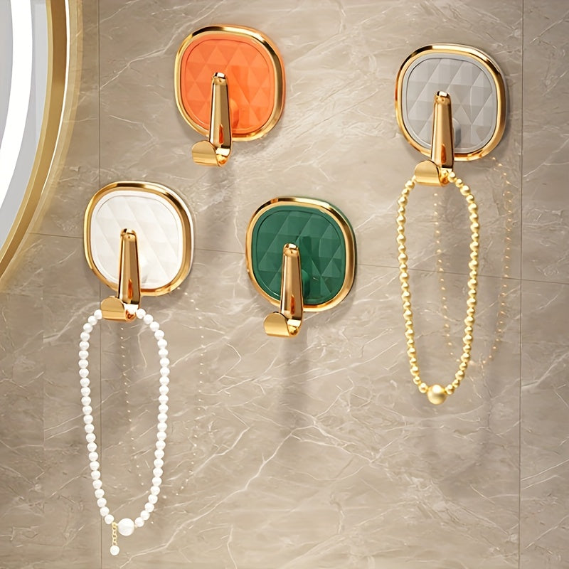 4 Golden Sticky Hooks for Easy Wall Mounting - Ideal for Clothes, Towels, and Robes in Modern Bathroom Decor.