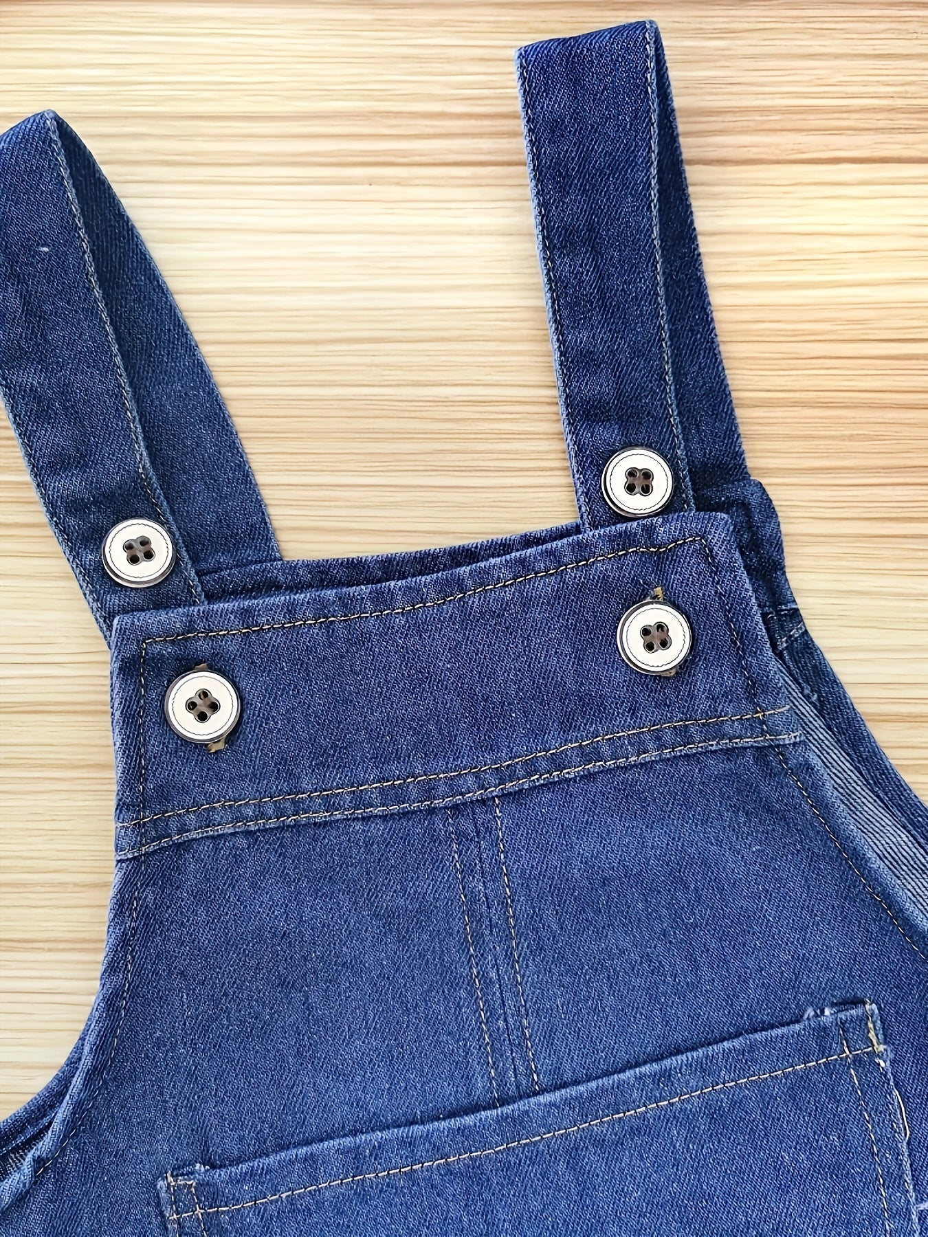 Infant & toddler girl's denim jumpsuit with pocket patches and ripped overalls, perfect for spring and summer.