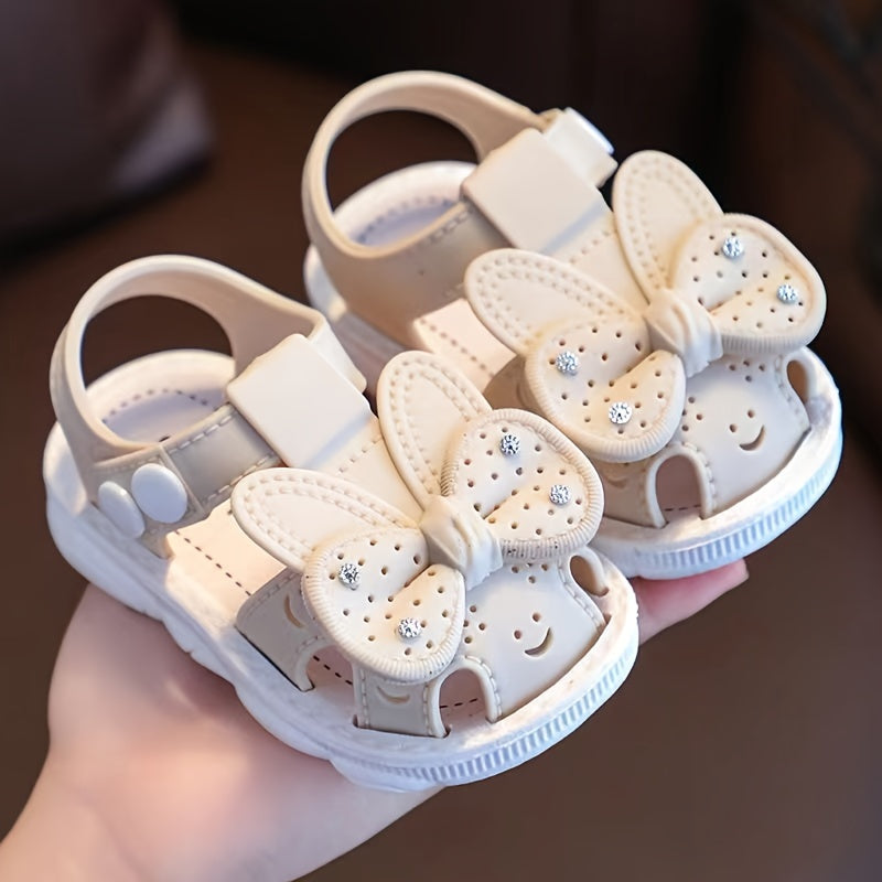 PVC low-top shoes for kids with cartoon and floral pattern, buckle closure, and soft sole.