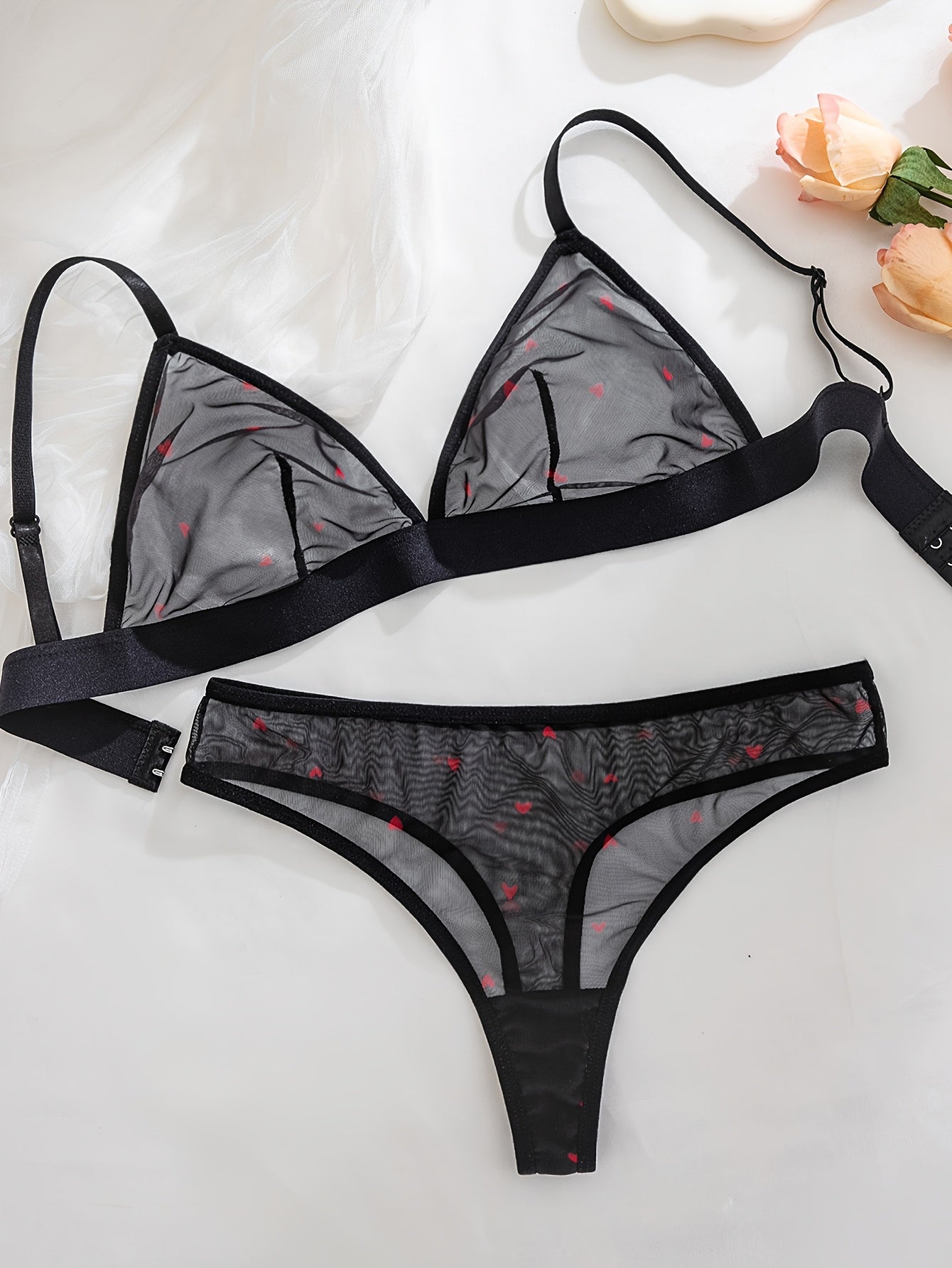 Sexy black sheer mesh lingerie set with red heart pattern, medium support, no underwire, drop waist, made of 90% polyester and 10% elastane.