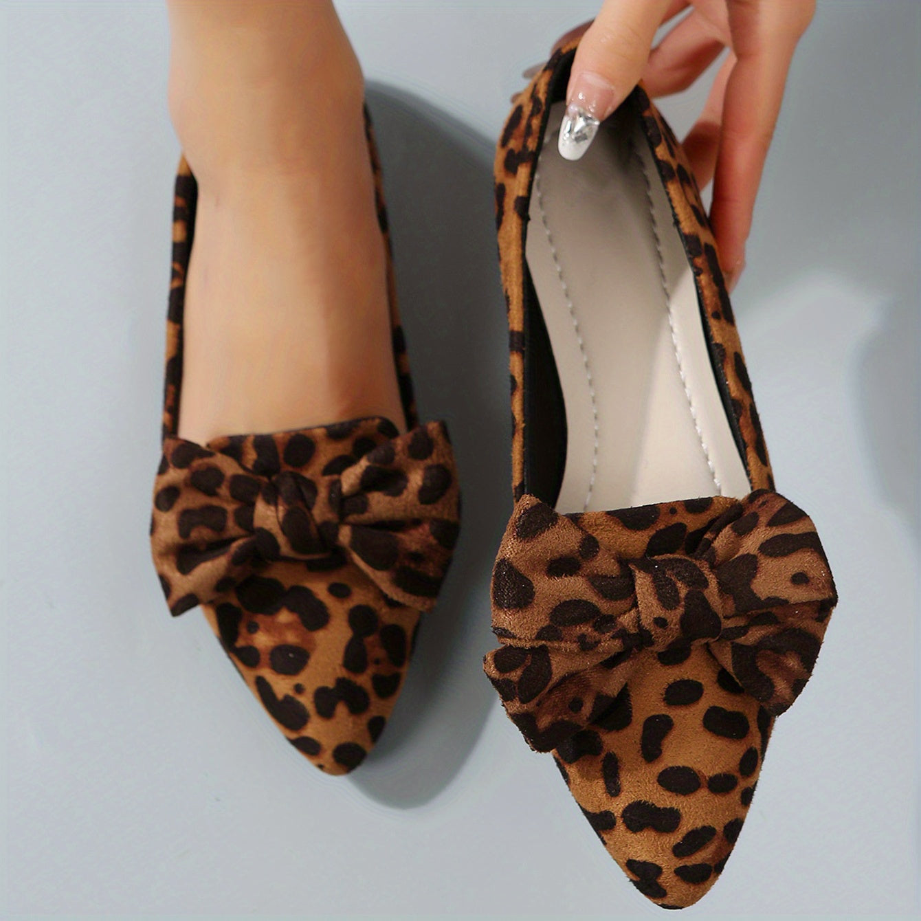 Leopard print flat shoes with bowknot decor and point toe, lightweight slip on style.