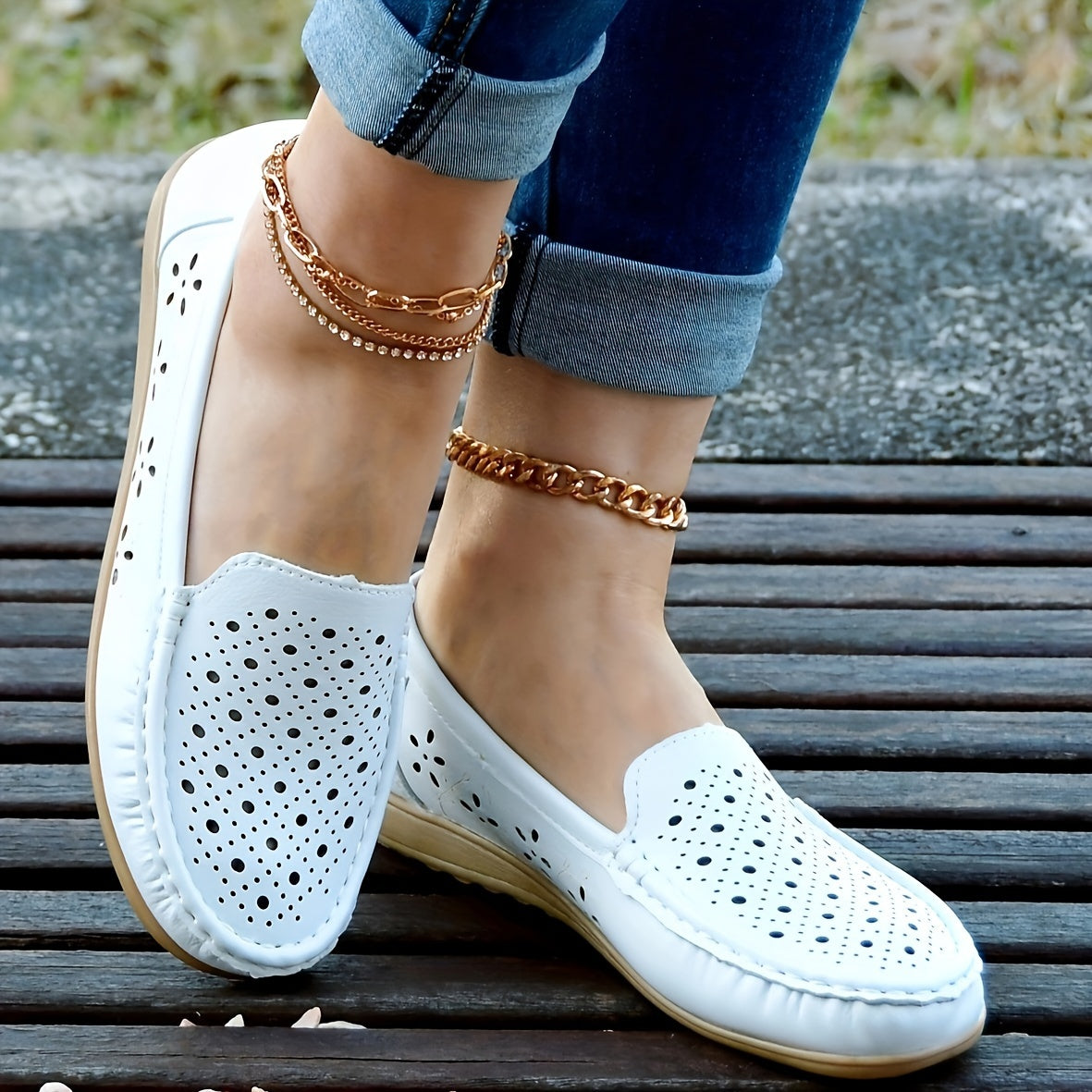 Women's white slip-on loafers with perforated design for breathability, non-slip sole, round toe, and versatile casual style for all-season wear.