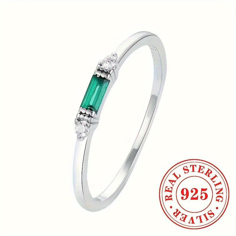 Delicate Sterling Silver Ring adorned with Baguette Cubic Zirconia and a Synthetic Green Gemstone, perfect for everyday wear or special occasions. This elegant piece is suitable for stacking and makes a thoughtful gift for women.