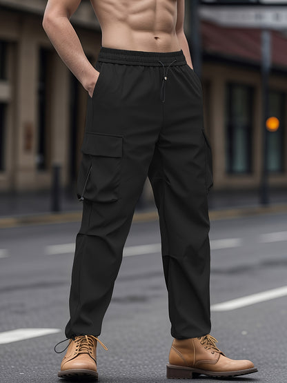 Unisex adult cargo pants with flap pockets, drawstring waist, and solid color.