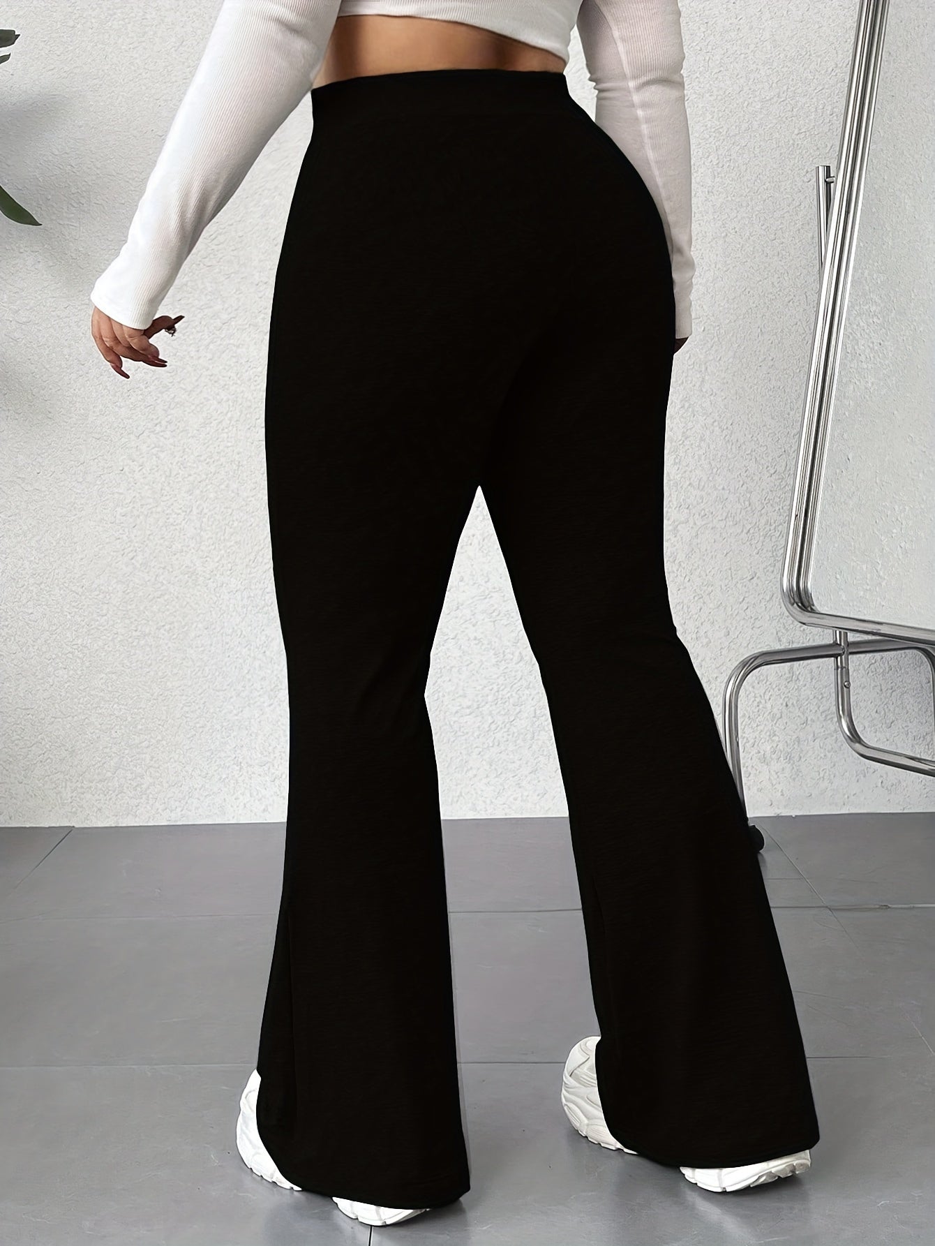 Solid color flared leg pants with a high waist, perfect for spring and summer in plus size women's clothing.