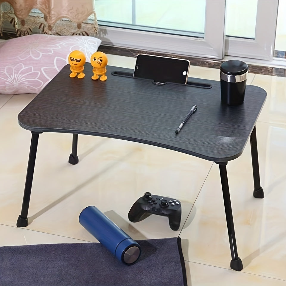 Portable laptop desk that can be used as a bed table, breakfast tray, standing desk, notebook stand, or reading holder for use on the bed, couch, sofa, or floor. Includes a convenient bottle holder and is foldable for easy storage.