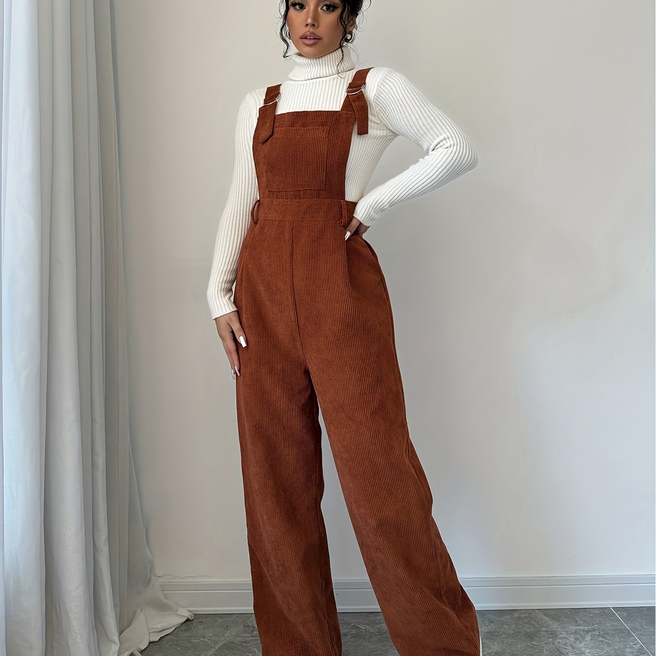 Spandex polyester jumpsuit for women with wide straps and button details, perfect for fall and winter.