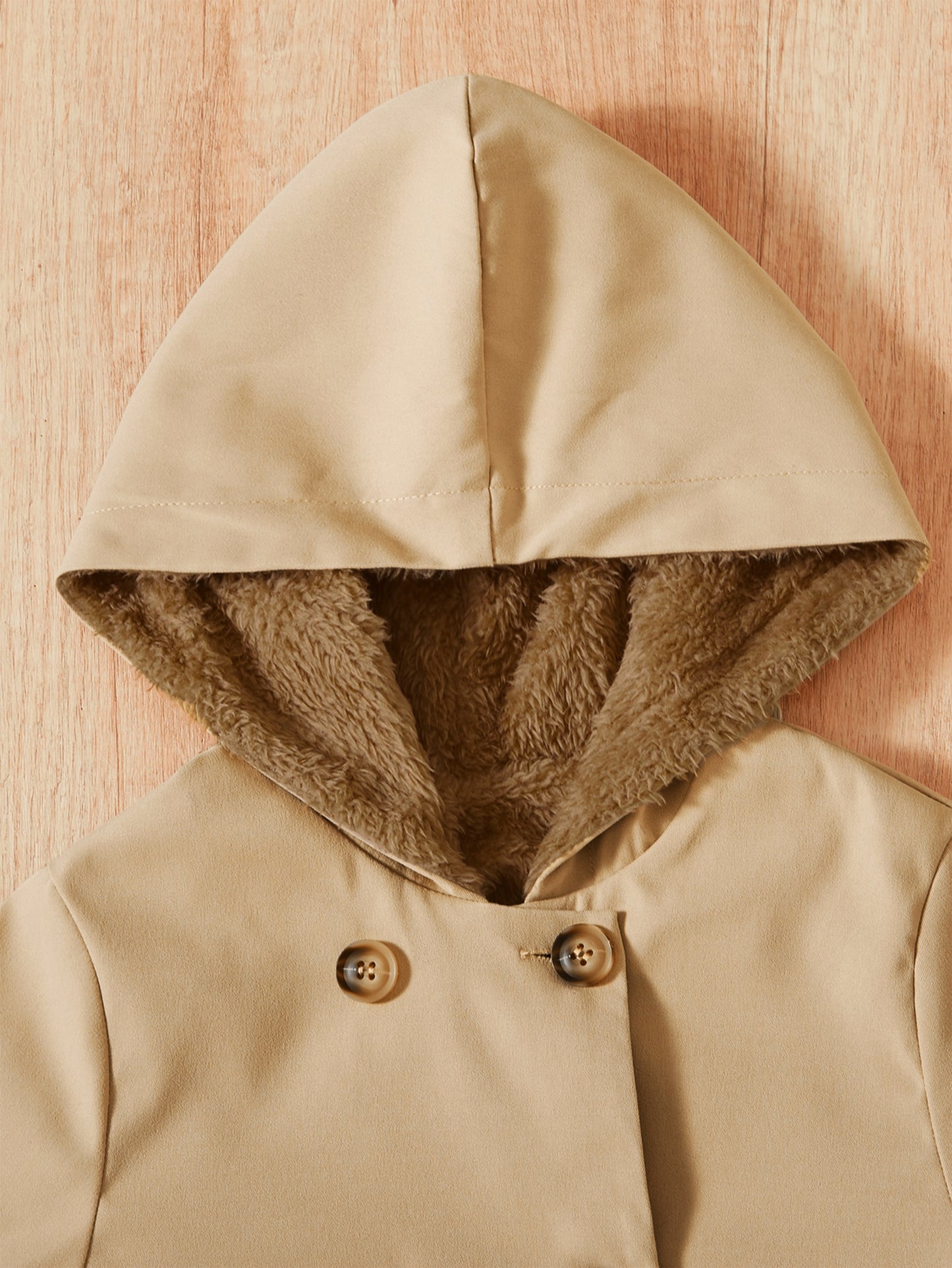 Padded hooded coat with a lightweight double-breasted style.