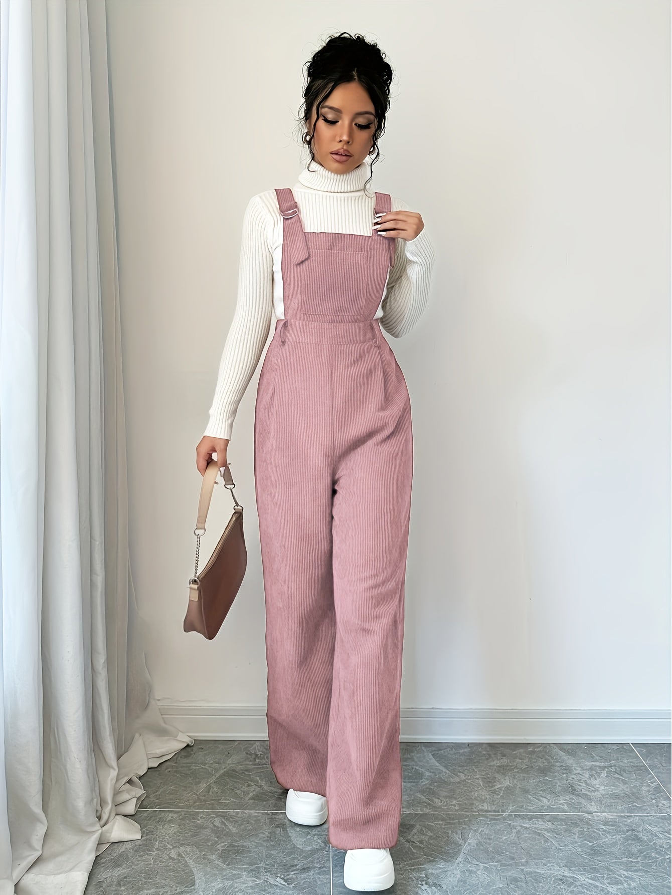 Spandex polyester jumpsuit for women with wide straps and button details, perfect for fall and winter.