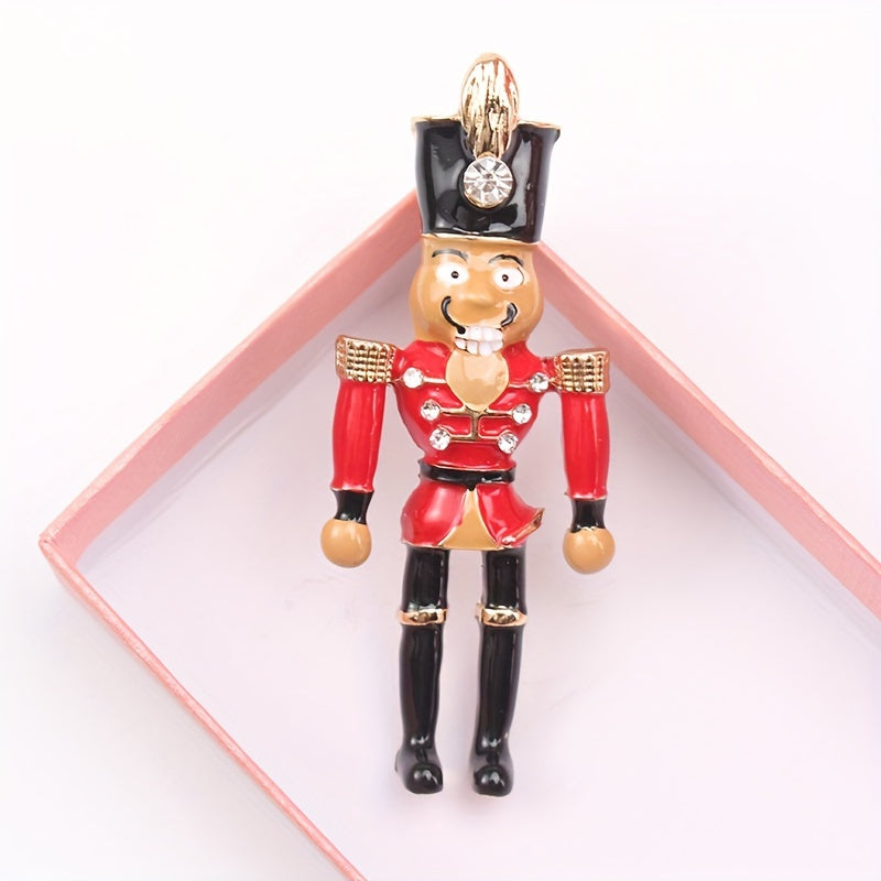 Holiday Nutcracker Soldier Brooch Pin, a festive accessory to adorn your lapel or clothing with a touch of whimsy. Perfect for adding a decorative flair to your outfit.