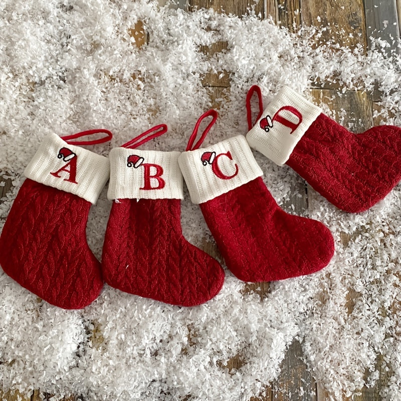 11" Christmas stocking with knitted alphabet design, perfect for hanging on the Xmas tree or using as a gift bag. Made of polyester.