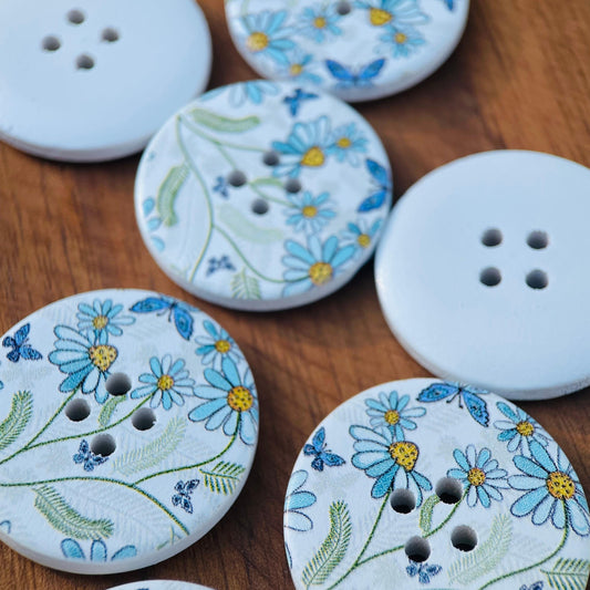 A set of 10 large decorative flower and butterfly buttons made of natural wood, each measuring 30mm in size and featuring 4 holes for sewing.