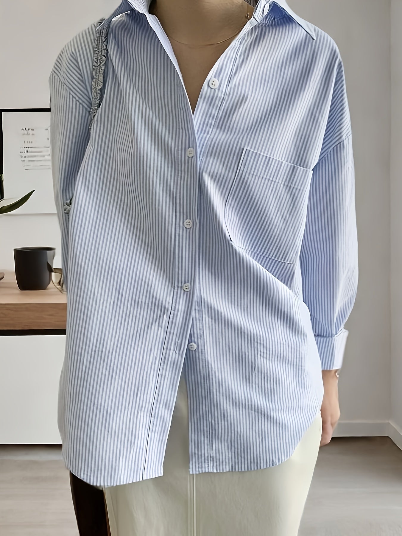 Striped print shirt with front buttons, polo collar, dropped shoulder long sleeves, pockets; versatile for spring and summer women's wear.