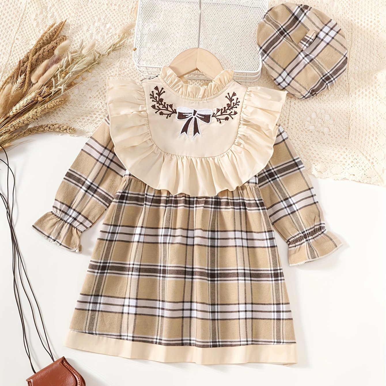 Stylish plaid dress with ruffle trim and matching hat, great for spring and fall. Machine washable.