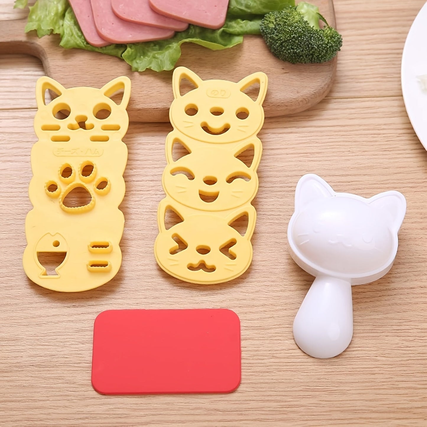 Set of 4 adorable cat-shaped molds for creating small rice balls, perfect for making cute cat-patterned sushi and bento. This kitchen tool is ideal for family gatherings and includes a nori punch knife for added versatility.