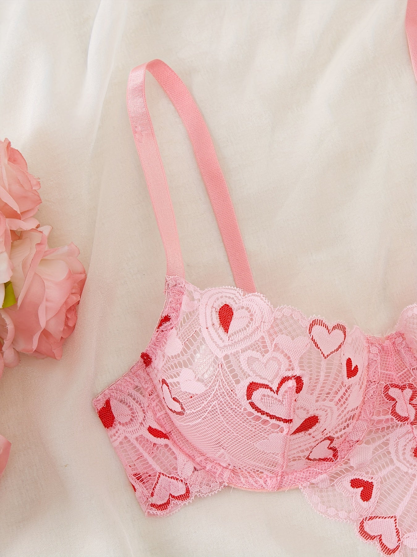 Pink heart-embroidered adult lingerie set made from polyamide and elastane blend, suitable for adults.