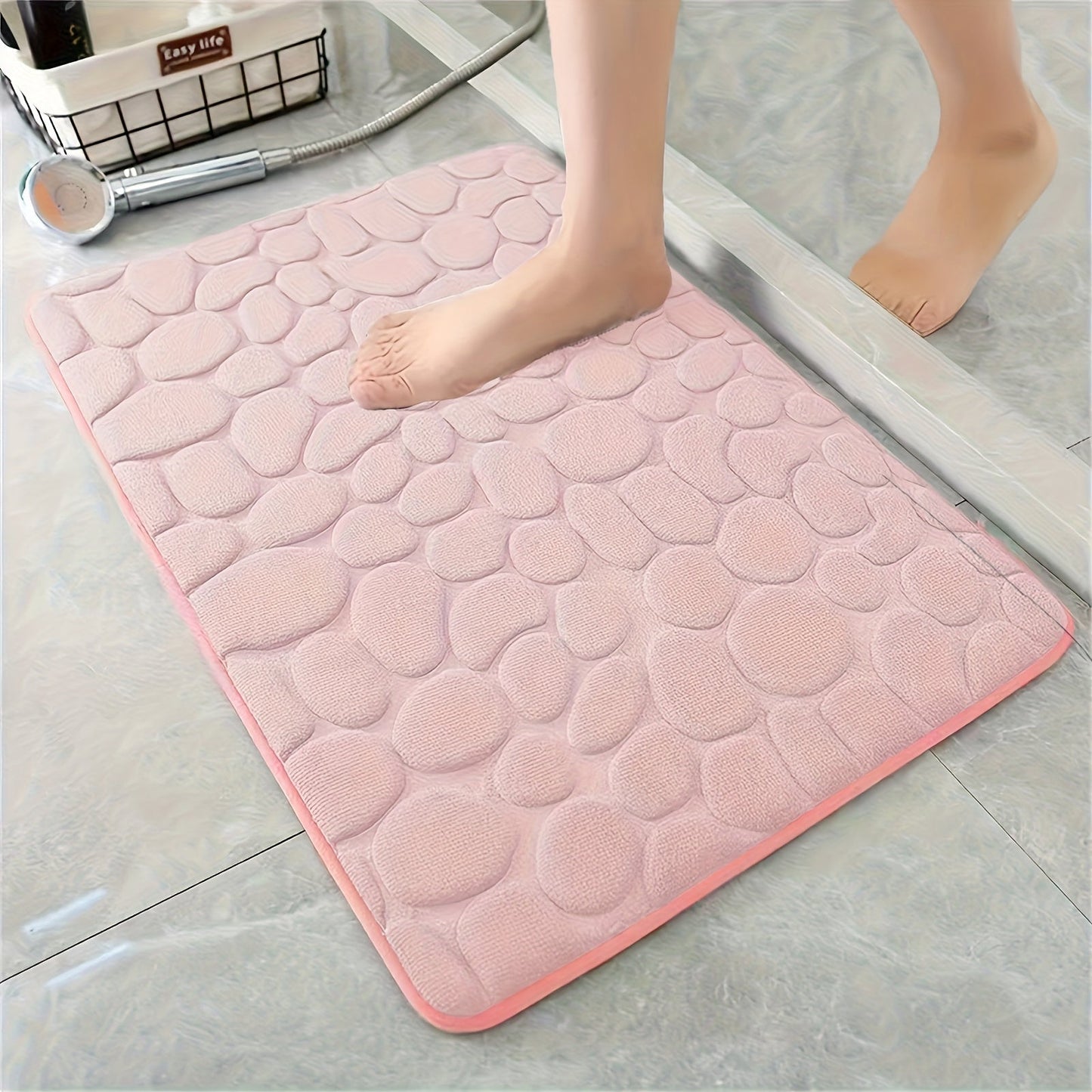 Soft and comfortable memory foam bath rug with cobblestone embossment, designed for rapid water absorption and easy washing. Featuring a non-slip backing, this rug is perfect for use in the shower room and as a stylish bathroom accessory. Ideal for