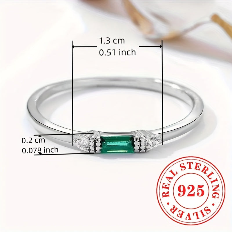 Delicate Sterling Silver Ring adorned with Baguette Cubic Zirconia and a Synthetic Green Gemstone, perfect for everyday wear or special occasions. This elegant piece is suitable for stacking and makes a thoughtful gift for women.