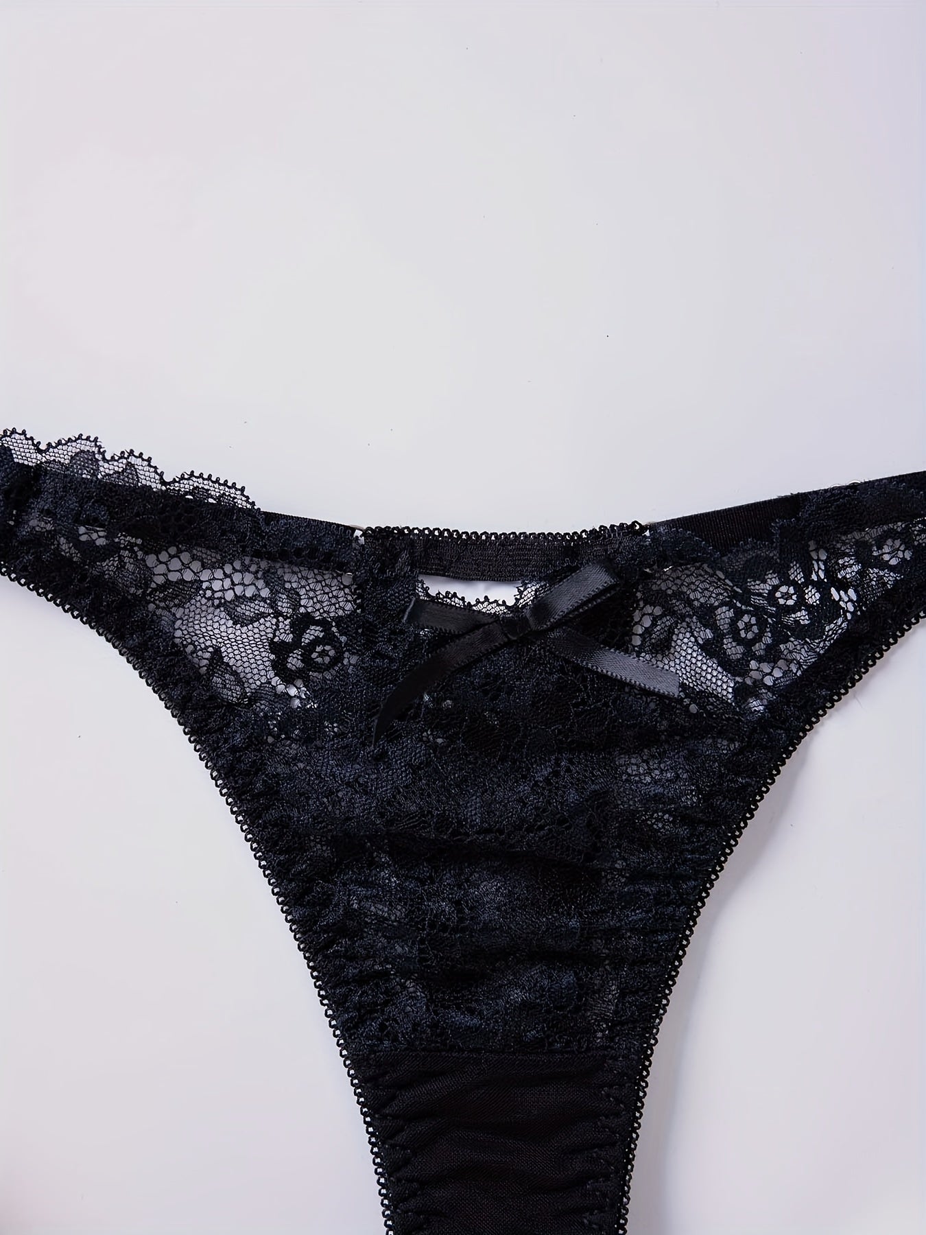 Women's sexy lingerie and underwear, featuring floral lace thongs and low waist bow tie panties with cut-out details.