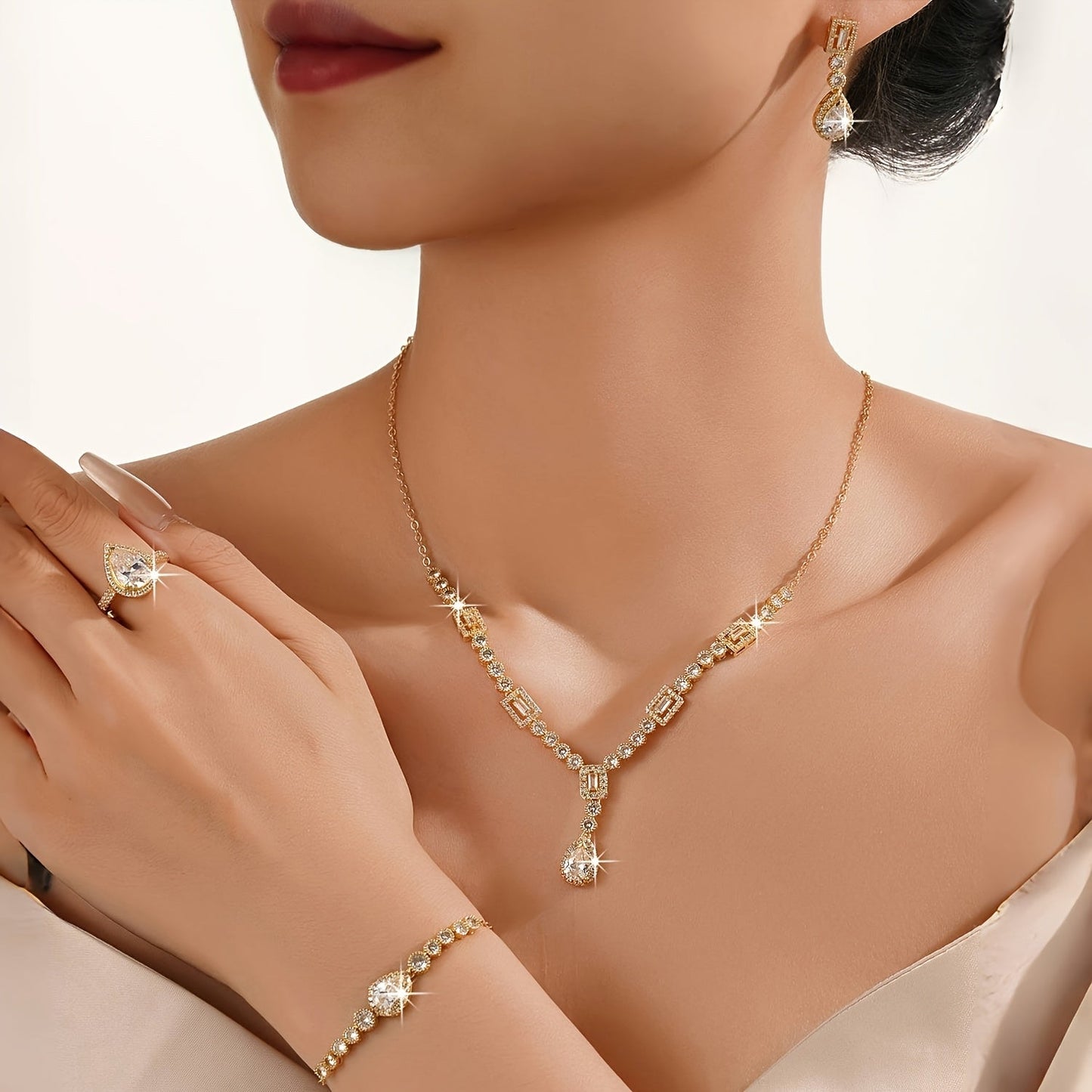 Luxury Jewelry Set Featuring 5 Pieces, Crafted from 18K Golden Plated Copper with Synthetic Cubic Zirconia Stones in a Geometric Teardrop Design. Includes Necklace, Earrings, Ring, and Bracelet, Perfect for Both Daily Wear and Wedding Occasions.