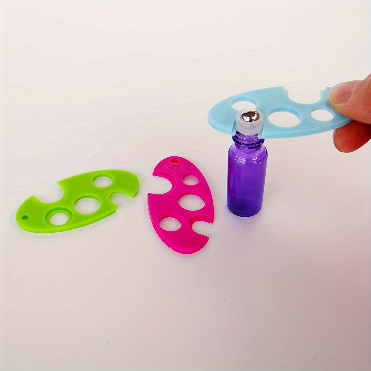 Durable tool for easy removal of essential oil bottle caps - colorful plastic opener with roller ball.