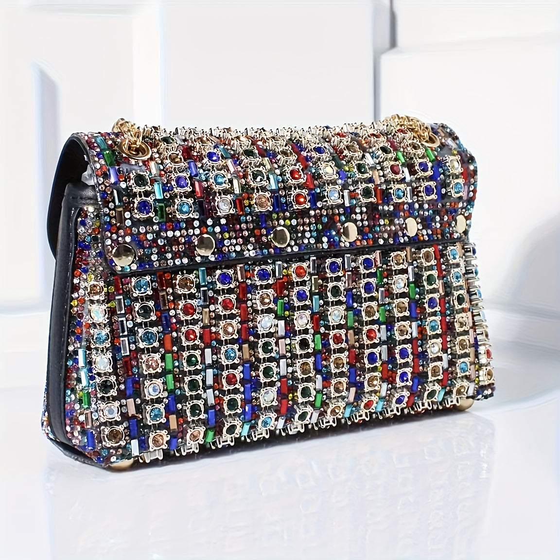 Stylish women's evening clutch with rhinestones and beads, adjustable strap, and magnetic closure, perfect for formal events.