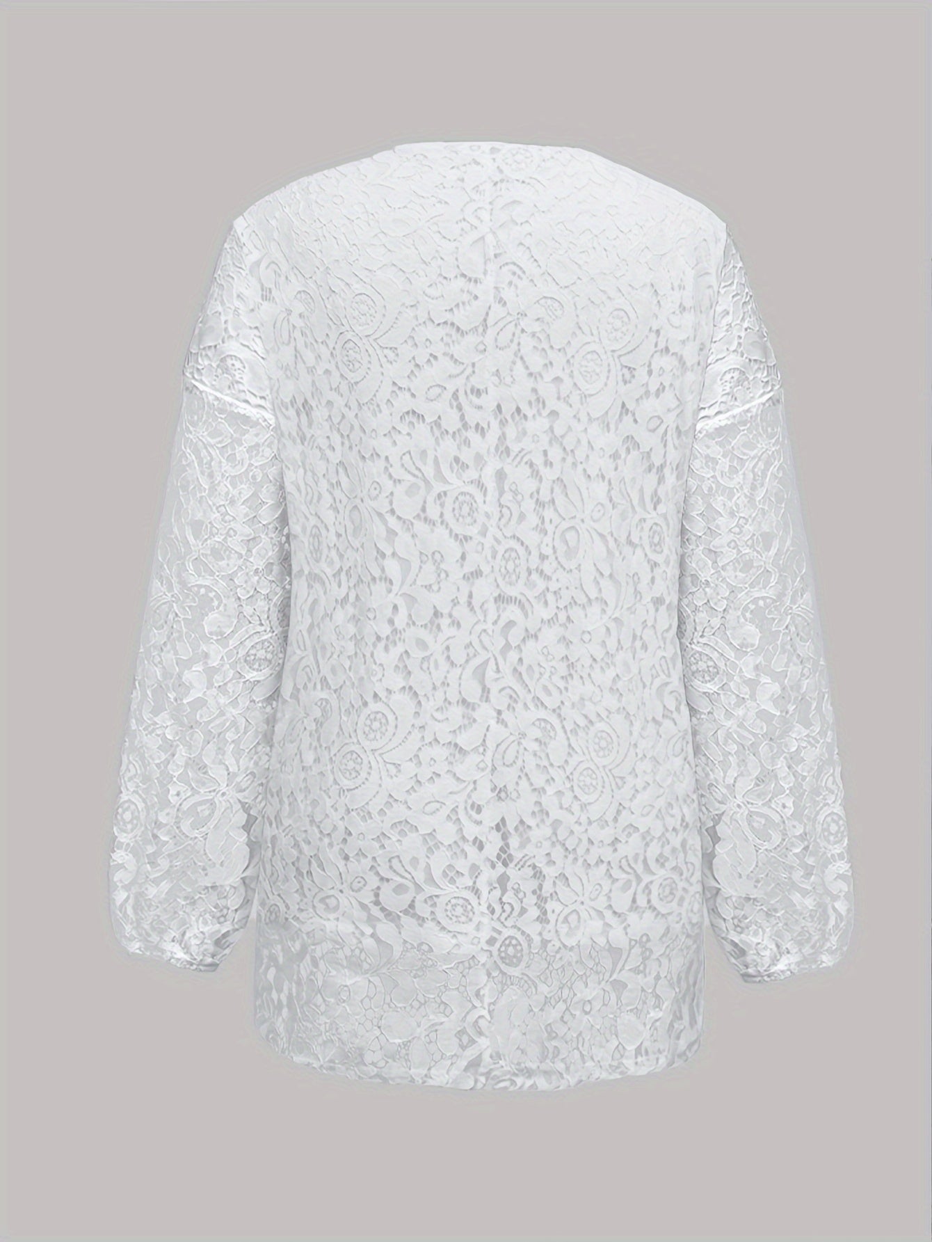 Plus size white V-neck long sleeve knit top with floral cut-out design, loose fit and lightweight polyester blend for summer wear. Features tassel necklace and lightweight knit fabric.