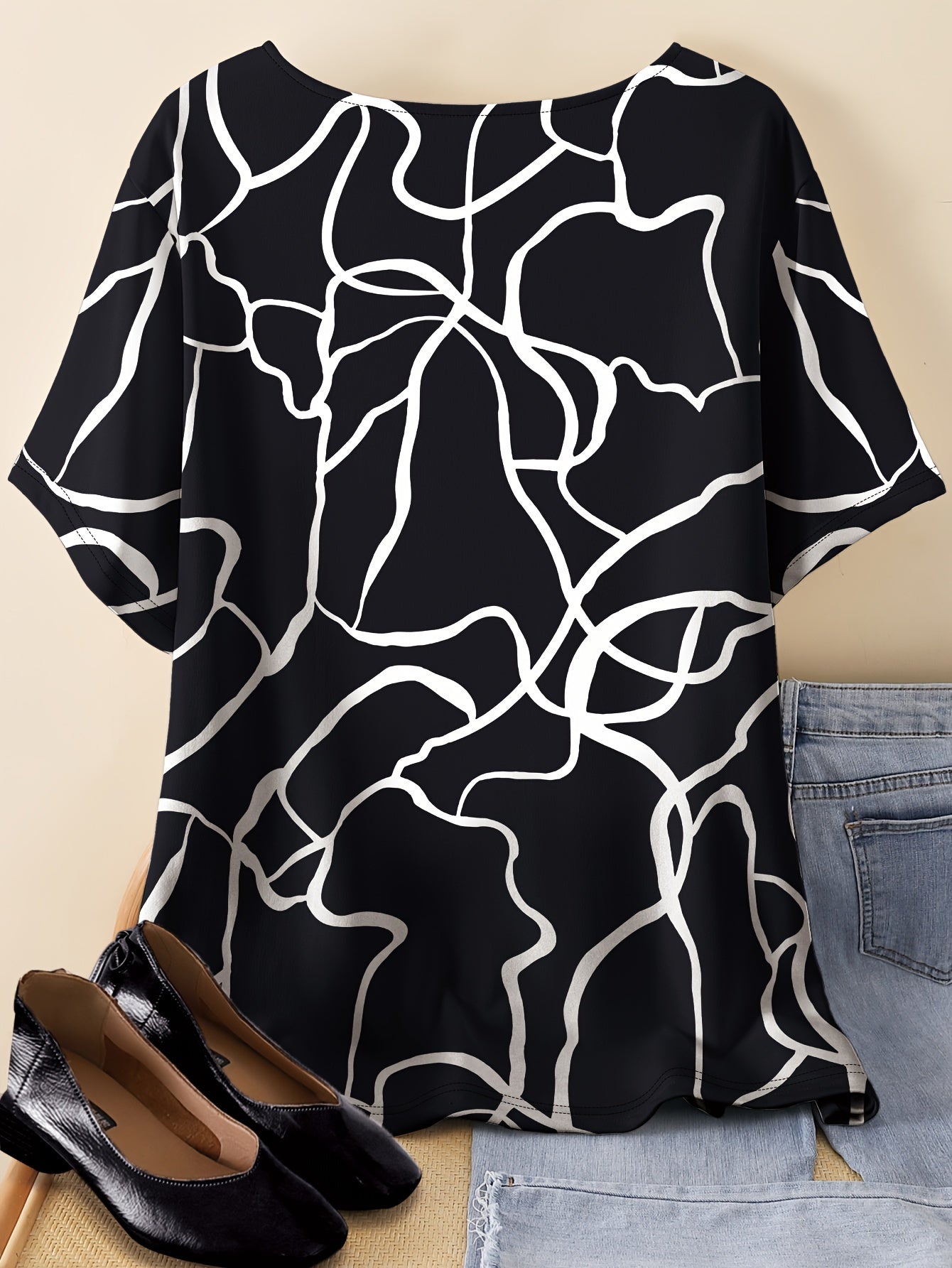 Casual T-shirt for plus-size women with unique line print, short sleeves, round neck, stretchy polyester blend; machine washable.