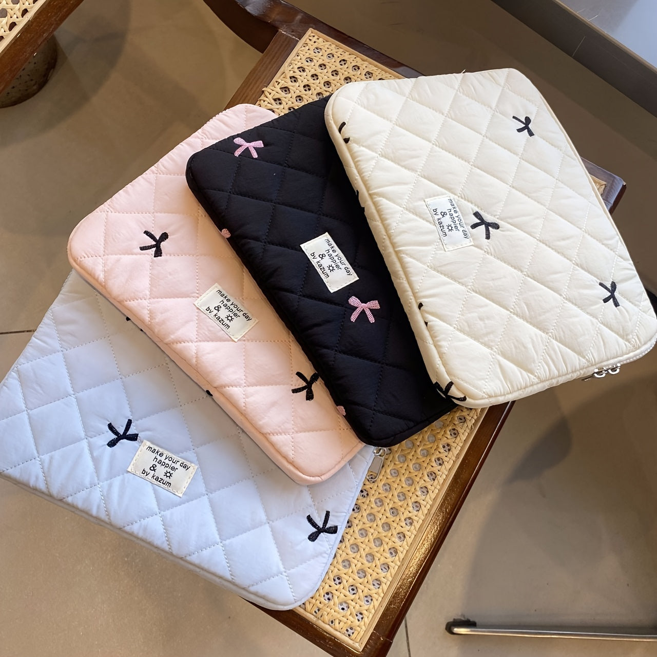 One laptop bag with ballet style bow embroidery, suitable for various devices.