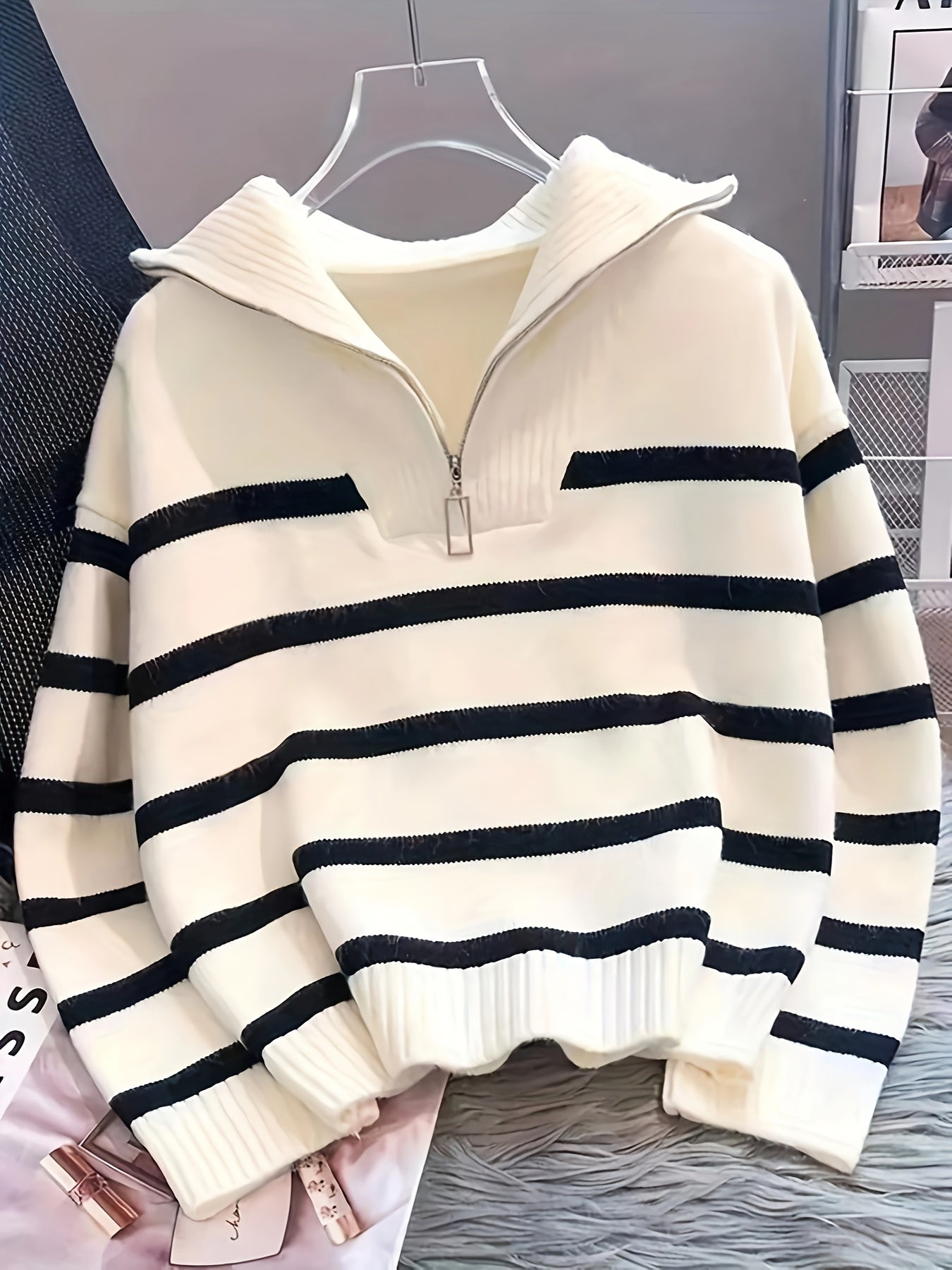 Black & white, striped zip-up hoodie for women in polyester knit with long sleeves and ribbed detail. Ideal for all seasons.