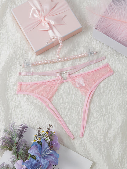 Stylish pink lace thongs for women, featuring a low-rise design with cut-out metal ring detail. Made from a breathable nylon/elastane blend for comfort during intimate moments.