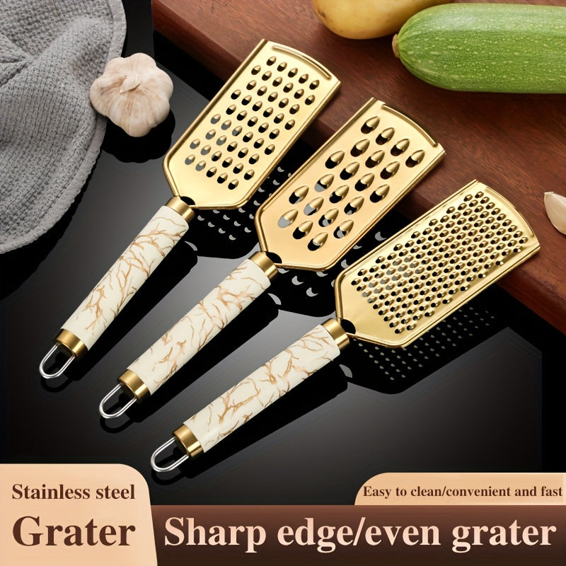 Stainless steel kitchen grater for shredding various foods, with a safe handle and luxurious golden appearance.