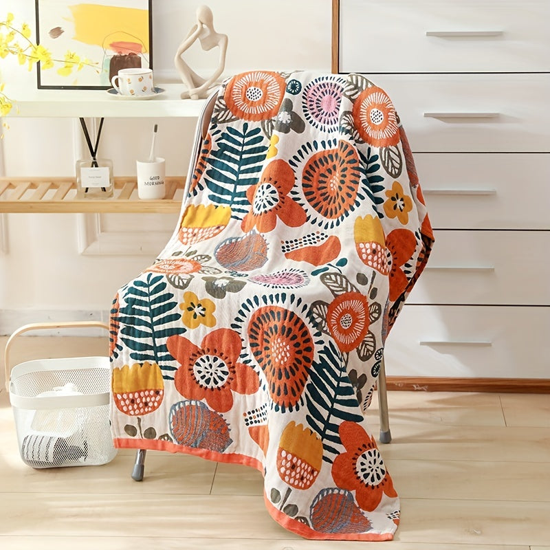 Large floral beach wrap towel made of super absorbent cotton with a four-layer design. Features a vibrant orange, blue, and green floral pattern. Soft, quick-drying, and perfect for home or travel.