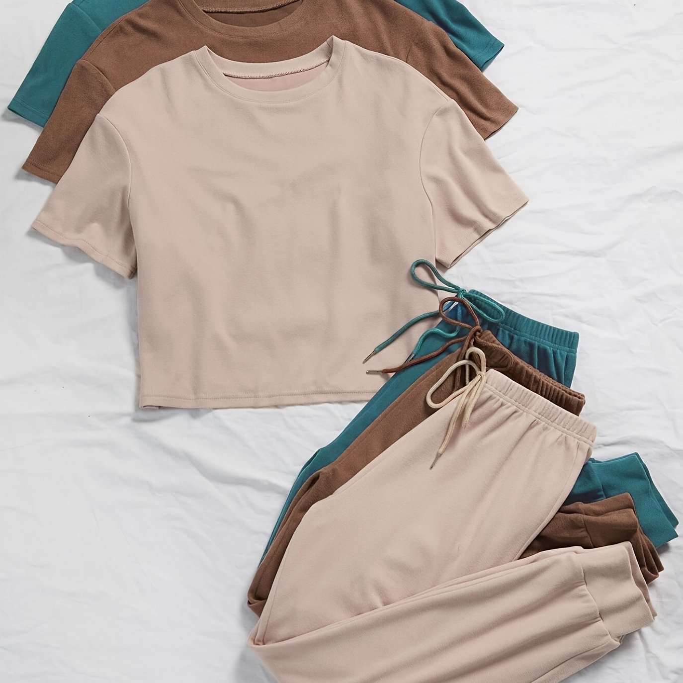 3 sets of women's solid color lounge sets with comfortable tee and tie front pants. Available in multiple colors for relaxed casual wear.