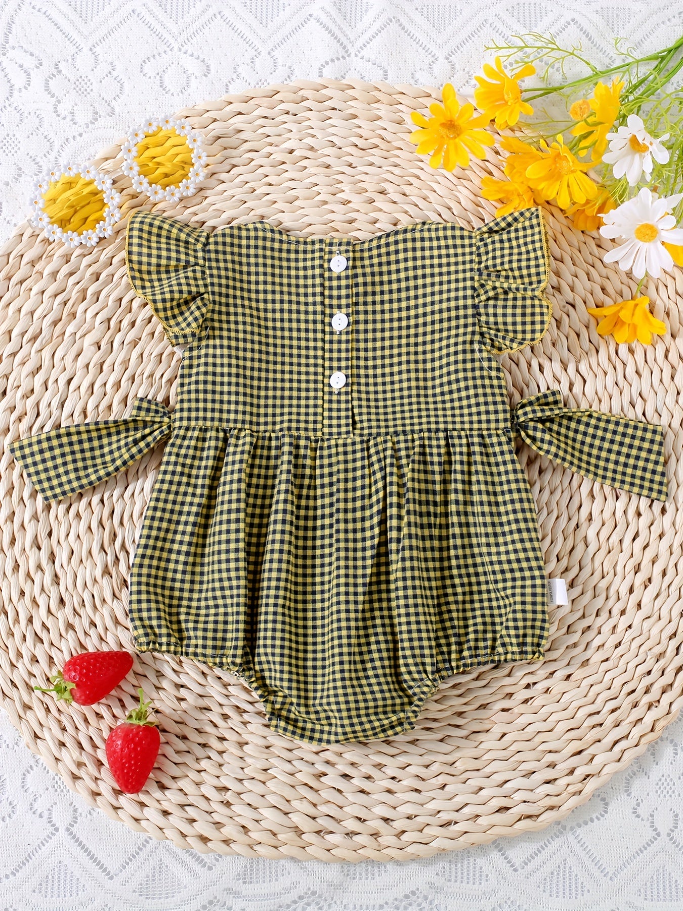 Infant girls' plaid onesie with strawberry embroidery and bow details, suitable for casual outdoor wear.