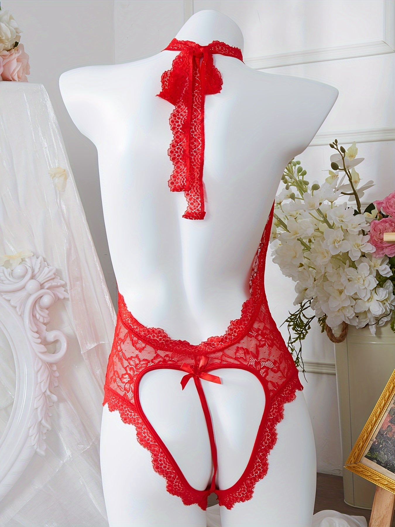 Red lace bodysuit with bow detail and floral print lingerie.