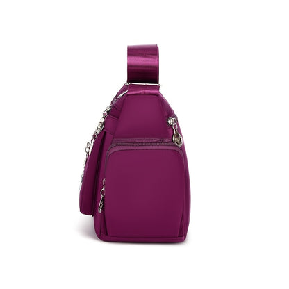 Women's versatile crossbody bag with adjustable strap, multiple compartments, zipper closure, and polyester lining for shopping, office, and travel, available in multiple colors.