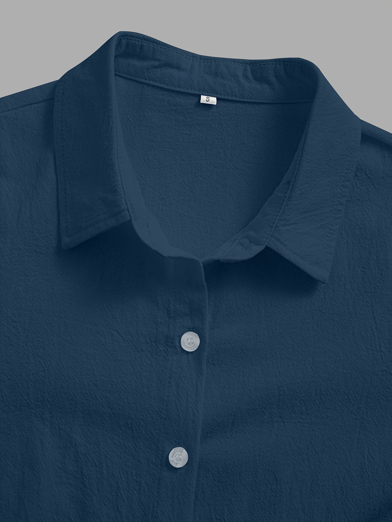 Loose-fitting collared shirt in solid color with front buttons and lace trim.