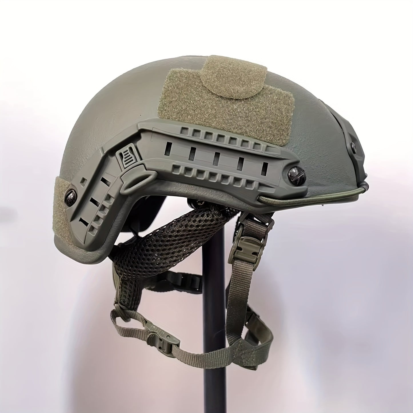 Green fiberglass tactical helmet with adjustable suspension for outdoor sports and CS paintball games.