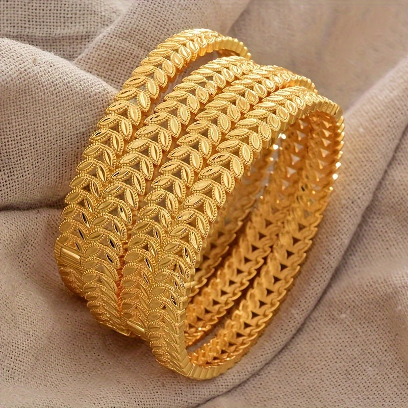 Set of four bangle bracelets, plated in 24K gold zinc alloy, featuring a luxurious floral design. This Ethio-Hawaiian jewelry is perfect for women, ideal for weddings, parties, and celebrations during Ramadan.