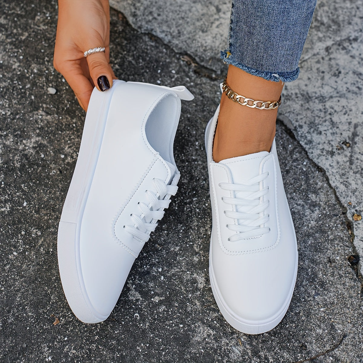 Versatile women's white sneakers with classic design, lace-up closure, round toe, and rubber sole for all seasons. Made with faux leather upper and comfortable fabric lining.