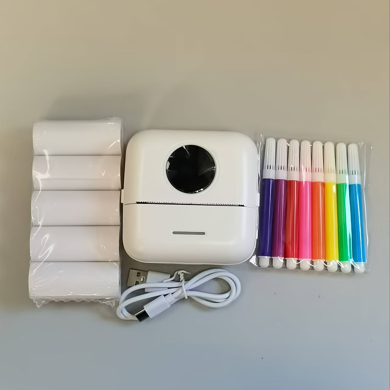 Mini thermal label printer with rechargeable battery for scrapbooking and diaries.