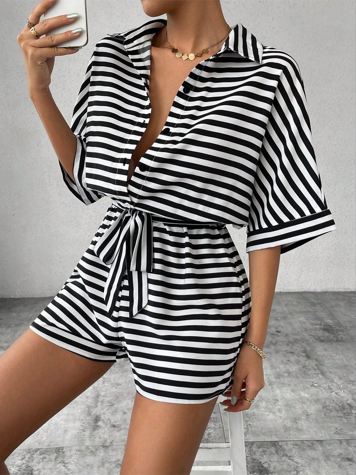 Button front romper jumpsuit with stripes, belt, short sleeves for spring and summer.