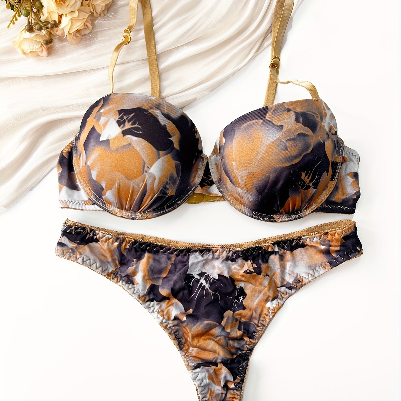 Red and black floral print push-up bra and thong set for women made of comfortable nylon blend. Ideal for casual attire.