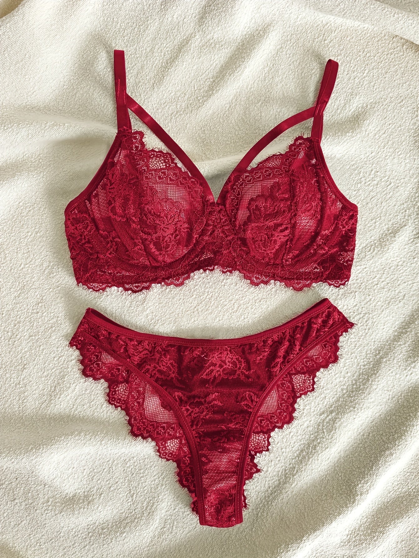 Women's semi-sheer lace lingerie set with underwire bra, mid-rise panties, and no padding.