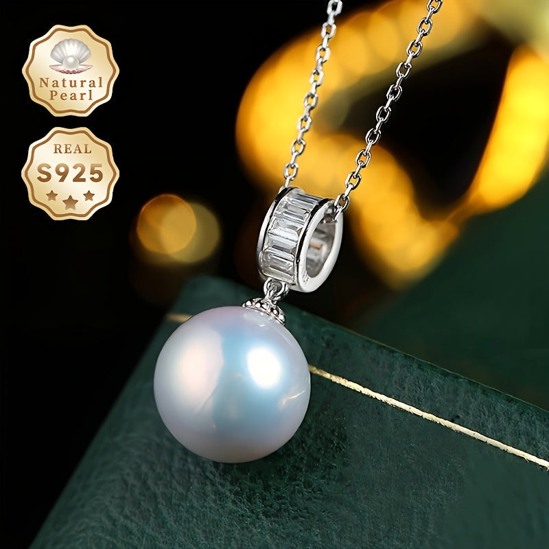 Surprise your loved one with this must-have gift - a stunning Pearl Necklace! This beautiful pendant necklace is made with S925 silver and features a 12-13mm round natural freshwater pearl. Each necklace is unique as natural pearls come in varying shapes