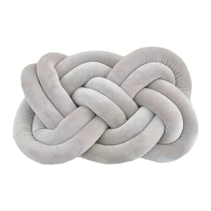 Knotted throw pillow for home decor, suitable for bed or sofa.